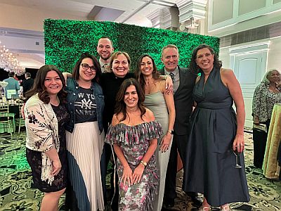 Leadership team infront of decor at the 2025 Crystal Ball