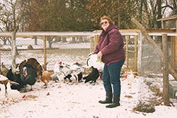 Brenda feeding chickens