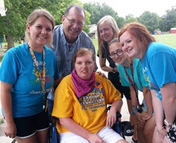 Lauren poses with camp staff and family for a picture.