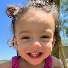 Smiling child named Diana in outdoor closeup