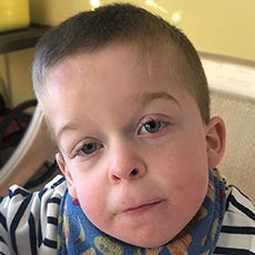 Close-up photo of 5-year-old Michael looking at camera