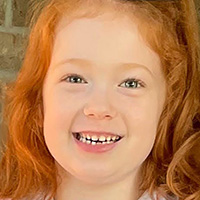 Zoey smiling with red hair