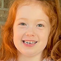 Zoey smiling with red hair