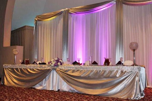 Crescent Room weddings-special events head table on stage with uplighting