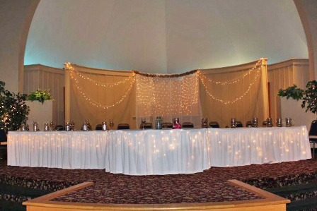 Crescent Room weddings-special events showing head table on stage