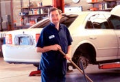 A client of New Frontiers Employment Services works in a car shop.