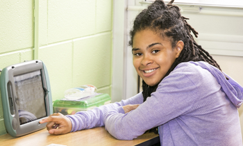 a girl using an AAC device