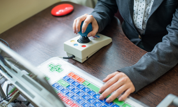 close up of someone using an adapted computer mouse