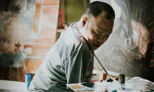 artist uses his face and neck to steer a paintbrush