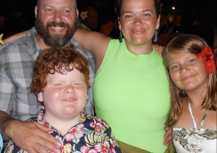 Zeke smiling with his family