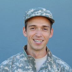 A male veteran smiles in uniform