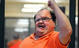 Lenny holds his fist up in an exclamation of excitement during an Accessible Martial Arts class