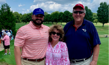 the flanagans stand together on a golf course