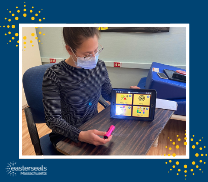 speech language therapist with mask on using iPad as a communication board