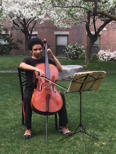 Adam Walden playing the cello outside