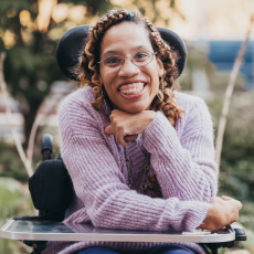 Allison smiles while sitting outside