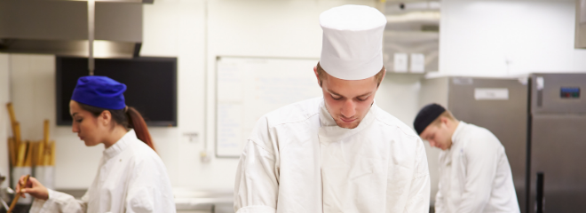 A person with a disability works as a chef in a kitchen