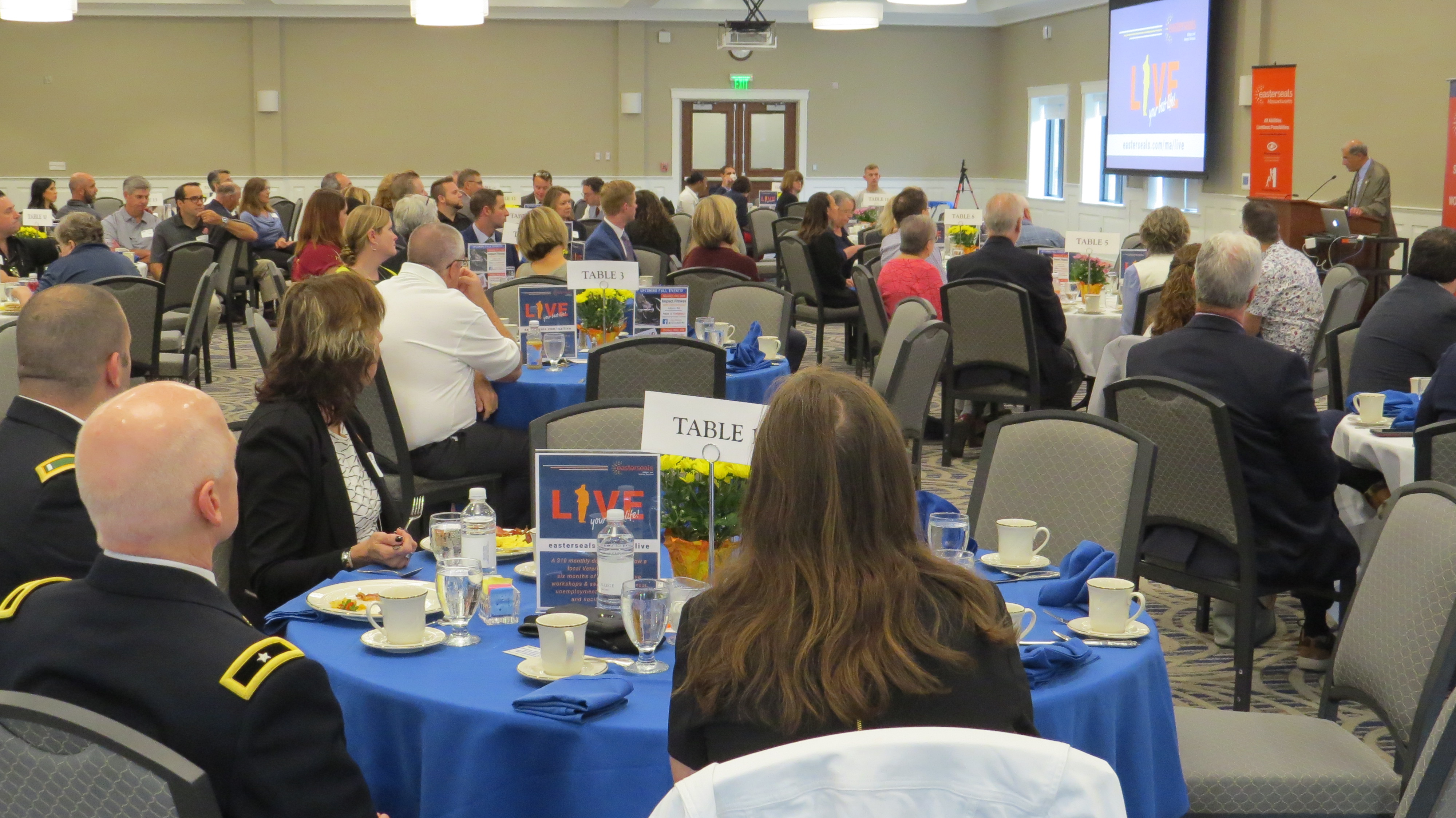 Attendees listening to Assumption College President Francesco Cesareo