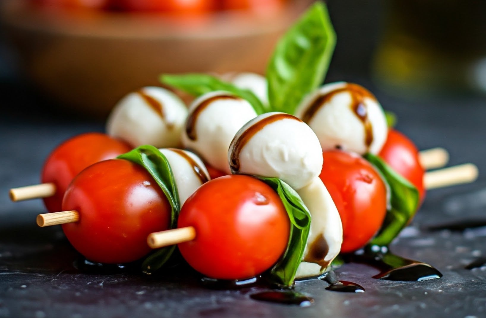 Close up of mozzarella, tomato, and basil on a skewer