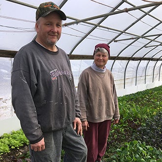 Bill Hayes and his wife standing in their greenhouse
