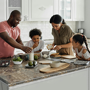 family in kitchen making lunch
