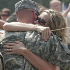Service member and significant other embracing