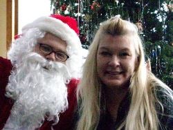 Santa and party-goer smile for the camera