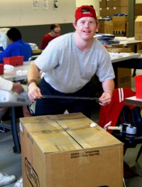 Packaging and Fulfillment employee smiles for the camera
