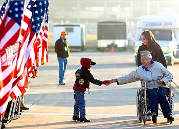 veteran shaking child's hand