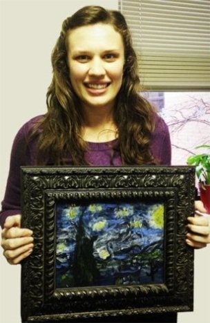 Nicole stands with painting by Jarrod, Easter Seasl North Texas CLASS client