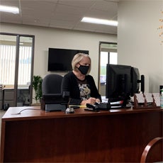 Senior Community Service Employment Program Paricipant Bev Sampson working at her desk.