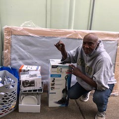 Veteran participant, Bennie Harris - with his move-in supplies and welcome-home kit, in his new apartment home.