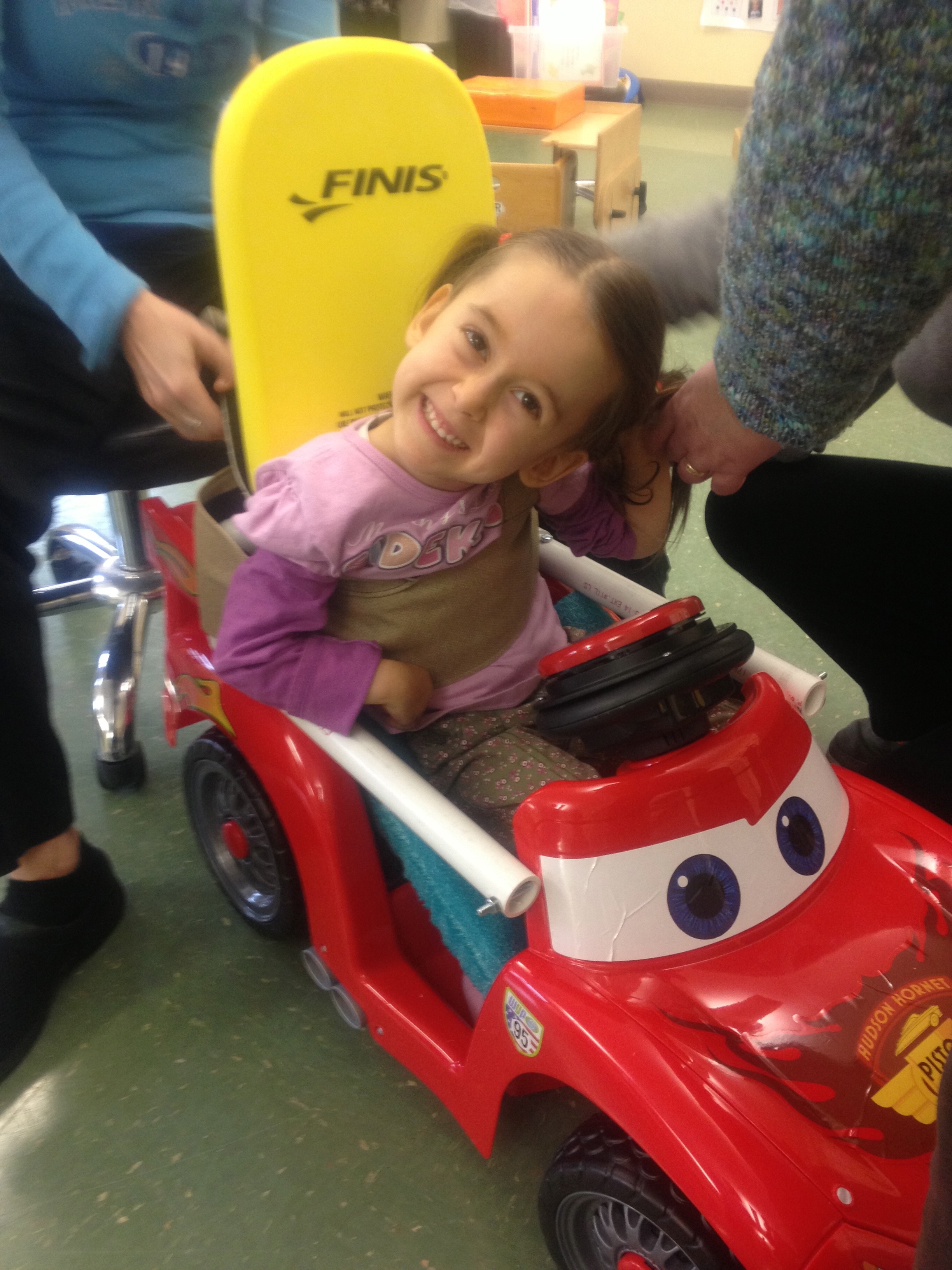 girl in adapted toy car