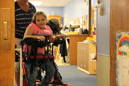 Girl in stander smiling