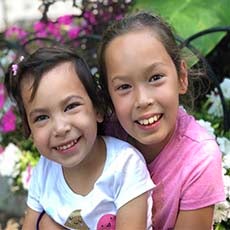 two girls very close smiling