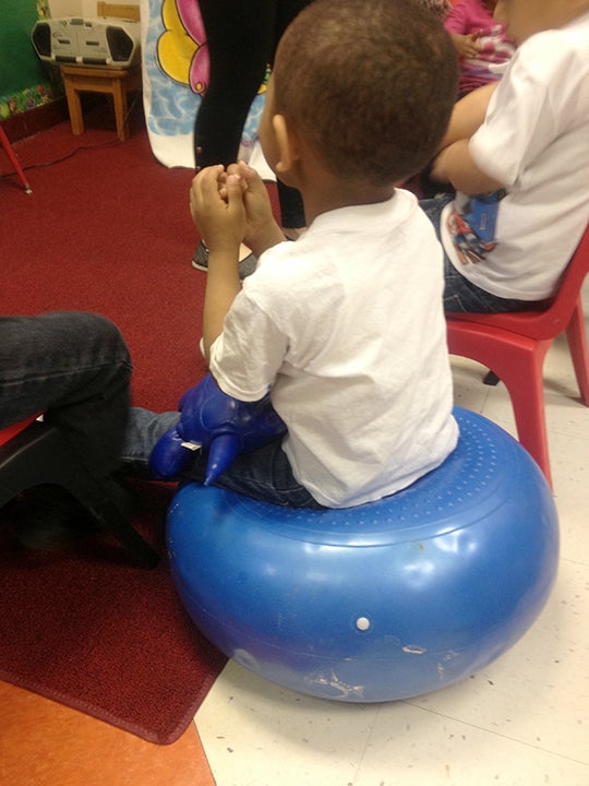 Boy sitting on movement cusion