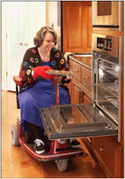 Woman in wheelchair using kitchen