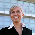 blonde woman in a business suit smiling