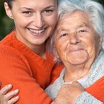 girl hugging grandmother