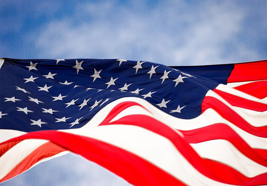 An American flag against a blue sky