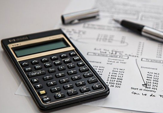A calculator with financial documents