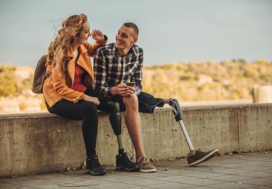 Two people with prosthetics talking