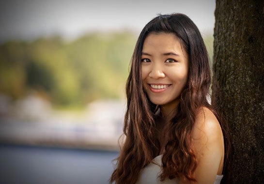 A woman outside, smiling