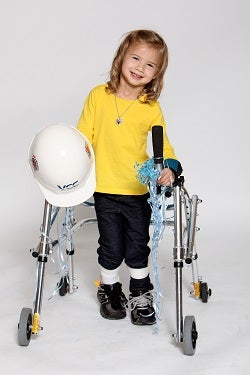 Haven standing with her walker