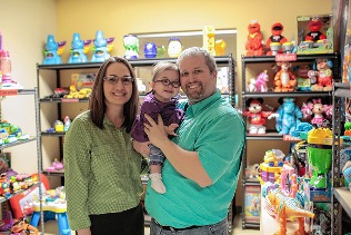 Heather Bennett, her husband and their daughter Katelyn in toy closet