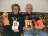 Joan and Al proudly display Rob's cards and art projects