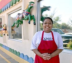 Kendra in front of the restaurant where she works