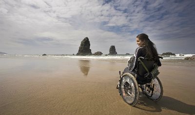 Woman in wheelchair on a beach