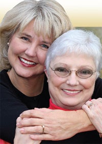 daughter hugging elderly mother