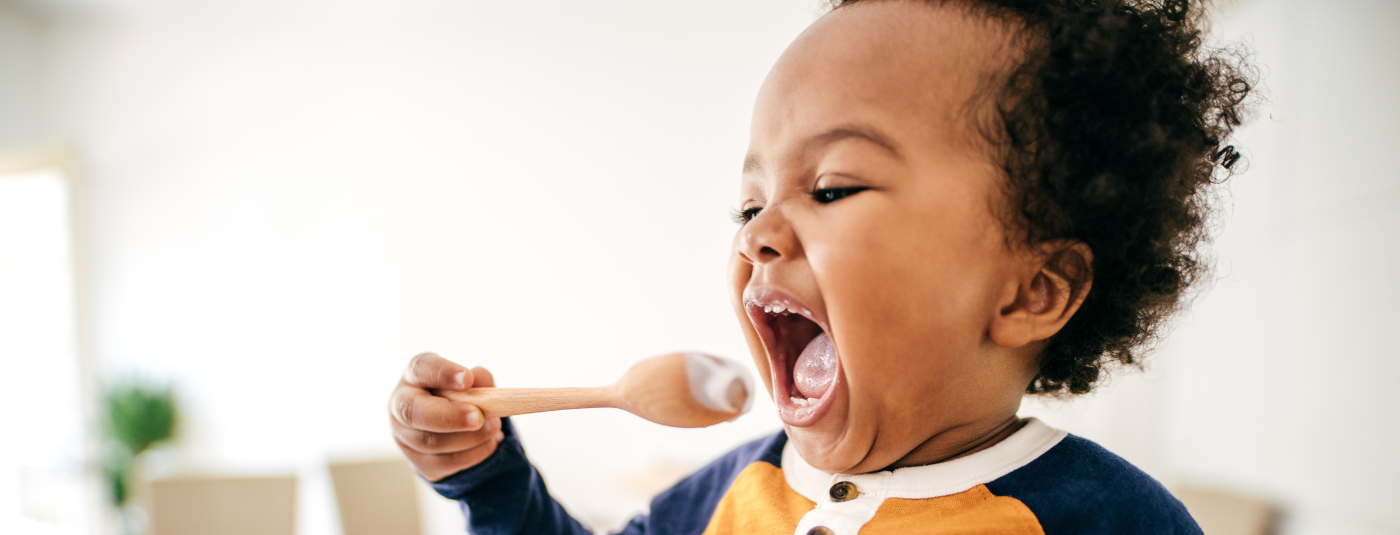 little boy eating yogurt 